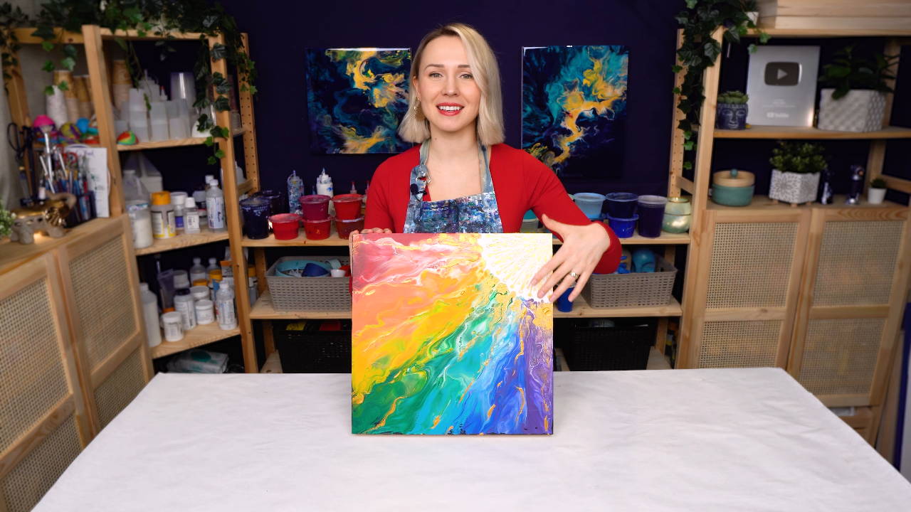 Female artist pouring acrylic medium for painting picture in fluid pouring  technique Stock Photo